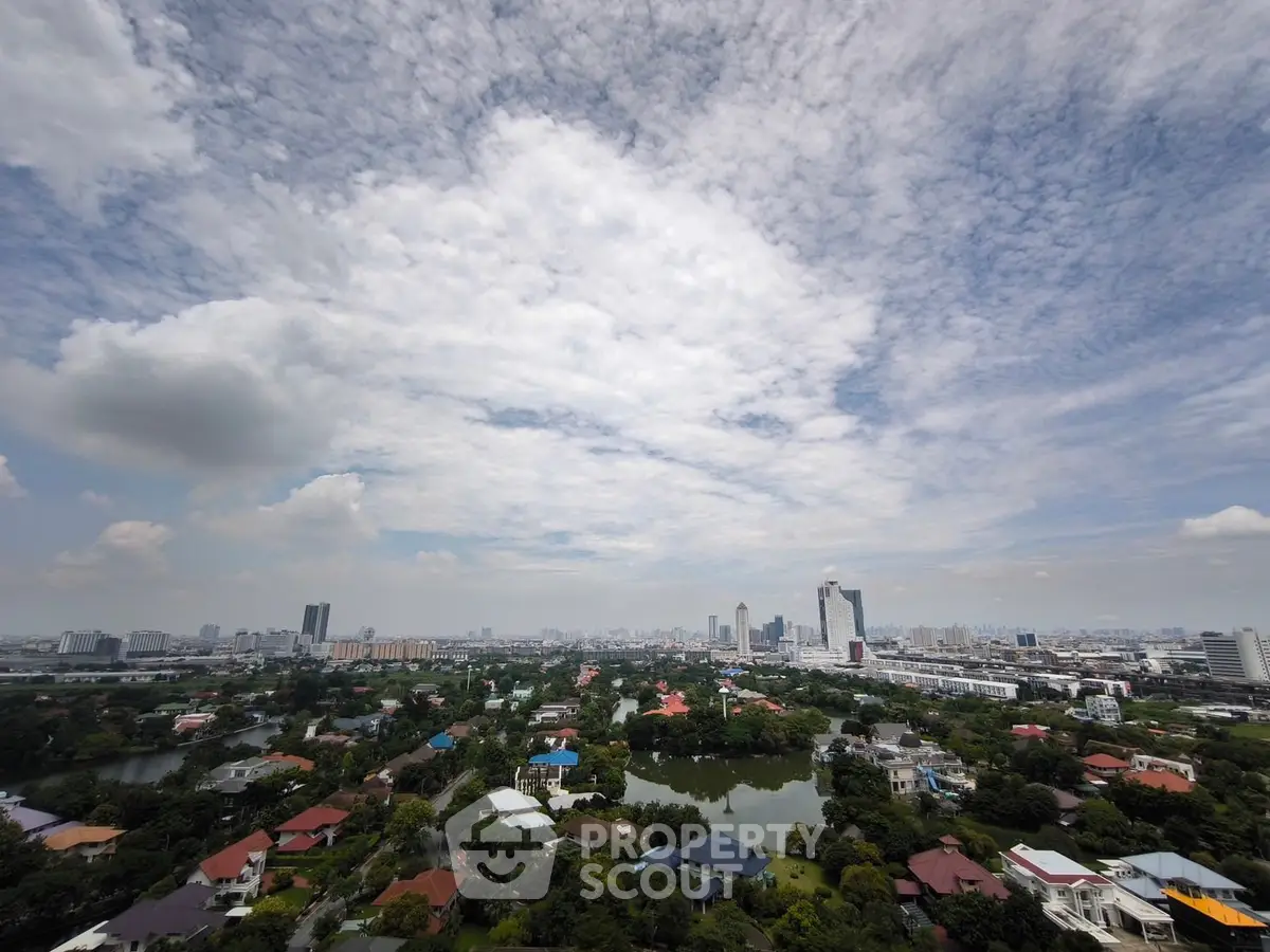 Stunning panoramic cityscape view with lush greenery and modern skyline.