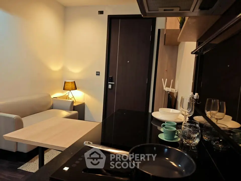Modern studio apartment with cozy living area and sleek kitchen