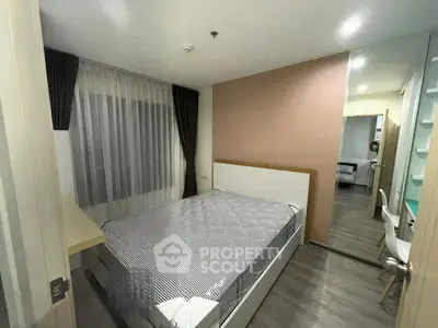 Modern bedroom with stylish decor and natural light, featuring a comfortable bed and sleek flooring.