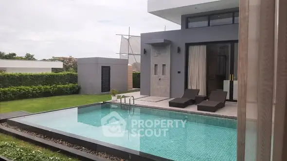 Luxurious modern villa with private pool and lush garden view.