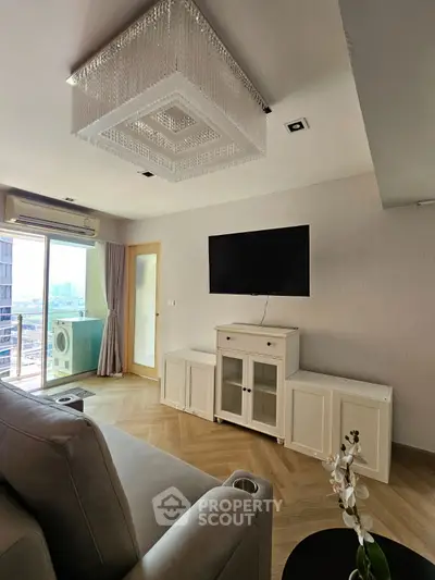 Elegant living room with modern decor and balcony view in a high-rise apartment.