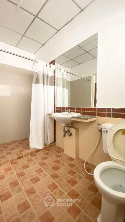 Spacious bathroom with modern fixtures and tiled flooring