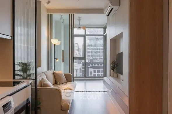 Modern living room with city view, cozy sofa, and sleek design elements.
