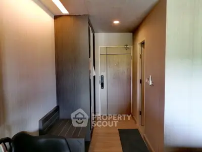 Modern apartment entrance with sleek wooden finishes and ambient lighting