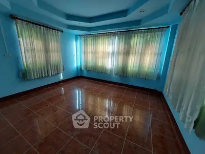 Spacious empty room with large windows and tiled floor, perfect for customization.