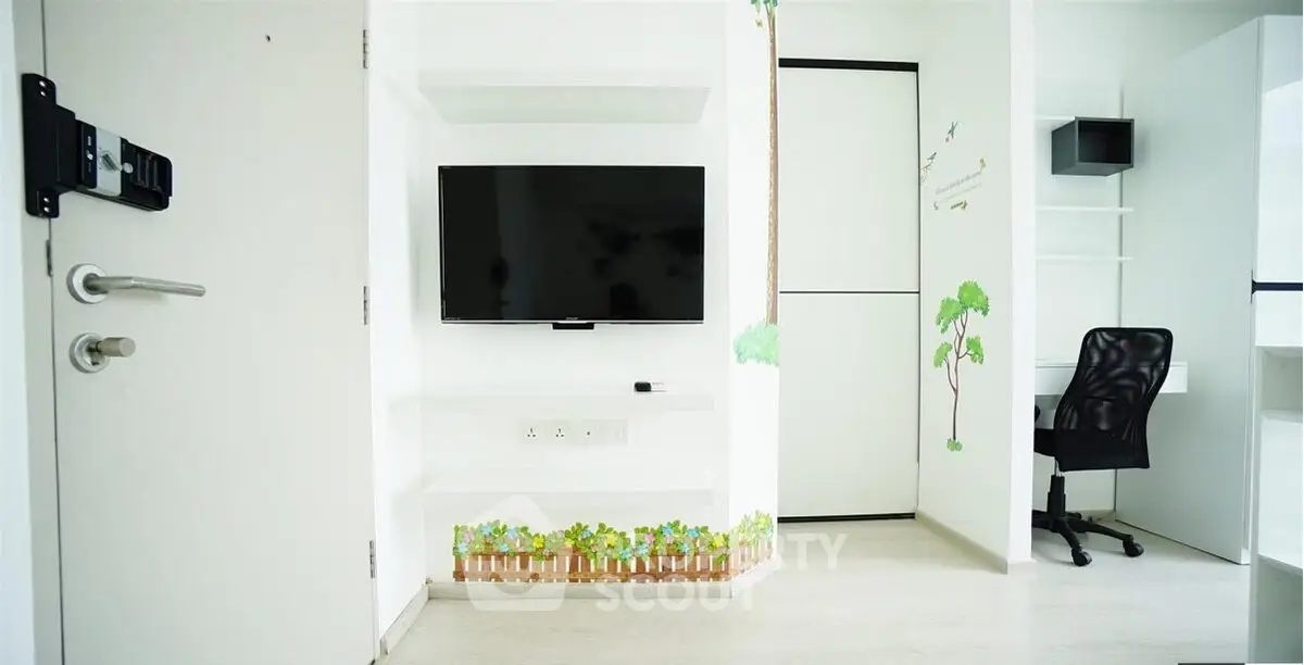 Modern minimalist study room with wall-mounted TV and sleek office chair.