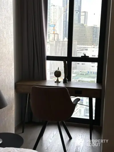 Modern study nook with city view, featuring a sleek desk and comfortable chair.