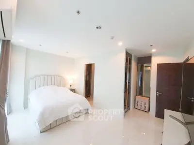 Spacious modern bedroom with elegant decor and ample natural light