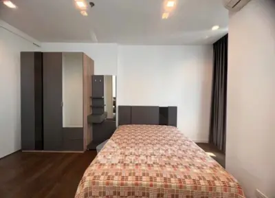 Spacious bedroom with modern furniture and ample natural light