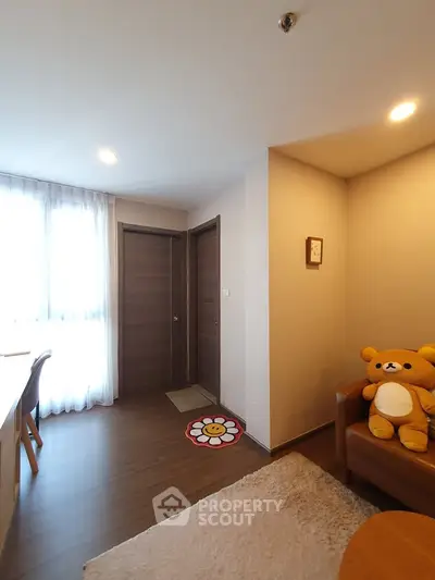 Cozy living room with plush bear decor and natural light