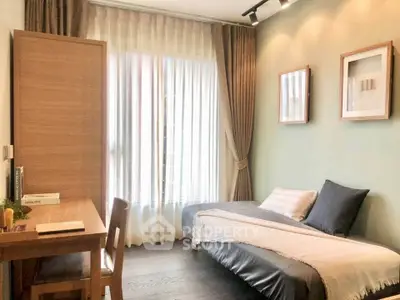 Cozy bedroom with elegant decor and natural light, featuring a stylish desk and comfortable bed.