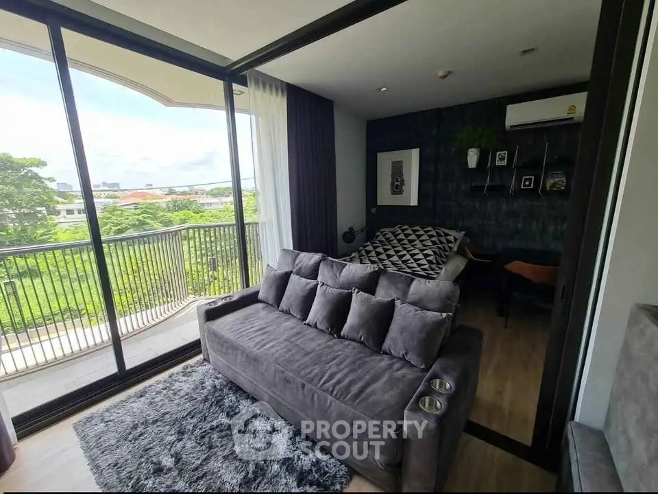 Modern living room with large windows and balcony view in stylish apartment