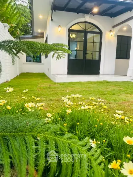 Charming garden view with lush greenery and elegant entrance in modern home.