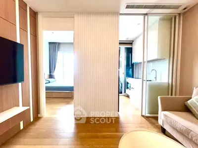 Modern apartment interior with open layout, featuring a cozy living area and sleek kitchen design.