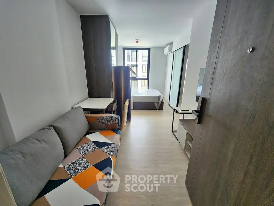 Modern studio apartment with stylish sofa and natural light