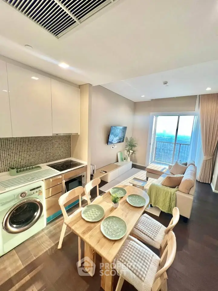 Modern open-plan living room and kitchen with stylish decor and natural light.