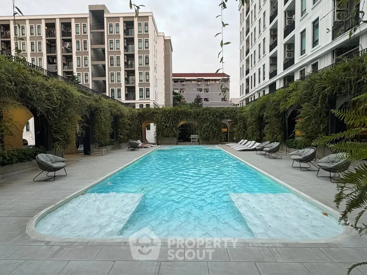 Luxurious apartment complex with stunning outdoor pool and lush greenery