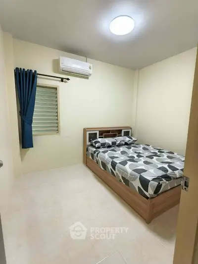 Cozy bedroom with modern decor and air conditioning in a minimalist style apartment.