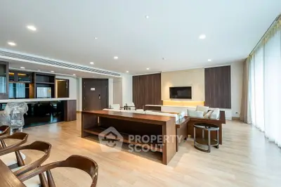 Spacious modern living room with open layout and elegant wooden furniture.