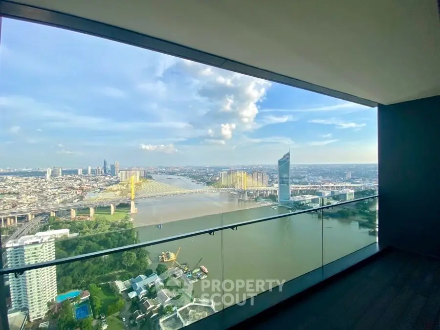 Stunning panoramic city and river view from a high-rise balcony, perfect for urban living.