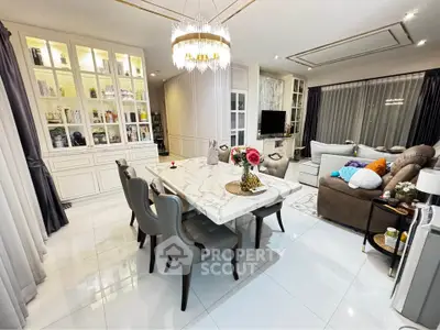 Luxurious open-plan living and dining area with elegant marble table and plush seating.