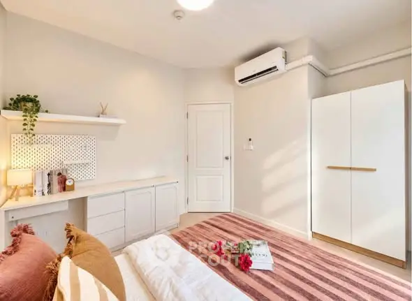 Bright and cozy bedroom with modern decor and ample storage space.