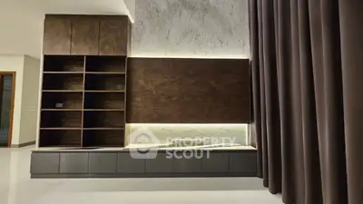 Modern living room with elegant built-in shelving and ambient lighting
