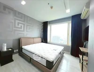 Modern bedroom with large window and stylish decor in urban apartment