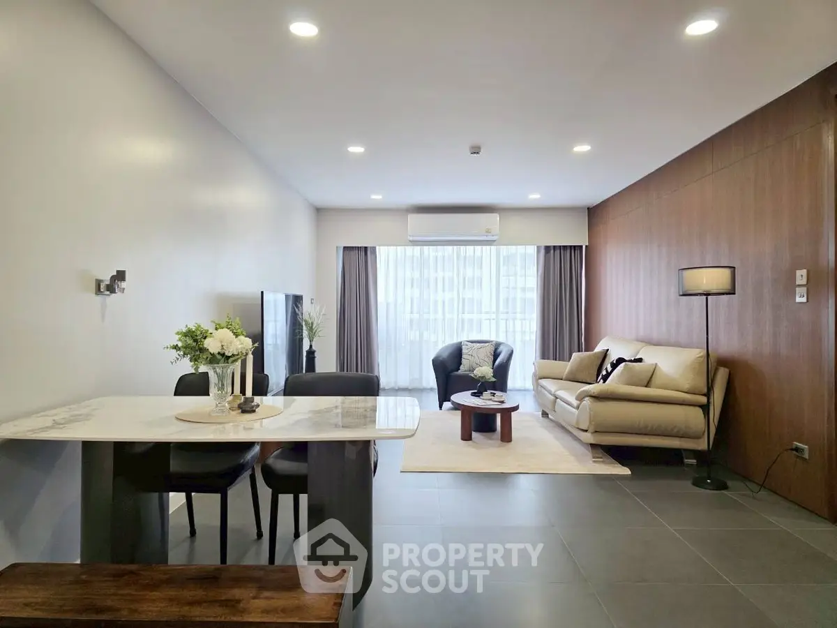 Spacious modern living room with elegant decor and ample natural light.