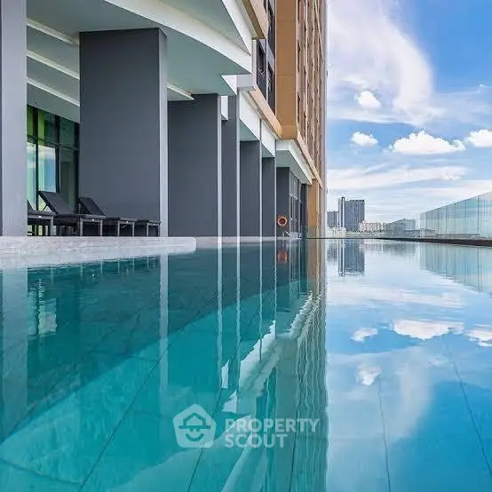 Luxurious high-rise building with stunning rooftop infinity pool and city skyline view.