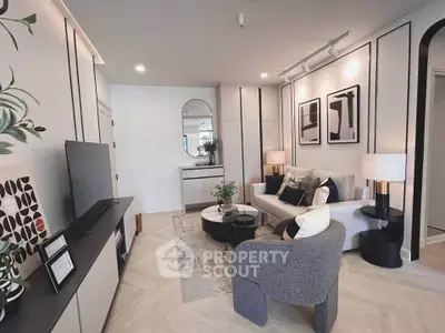 Modern living room with stylish decor, cozy seating, and contemporary artwork, perfect for relaxation and entertainment.