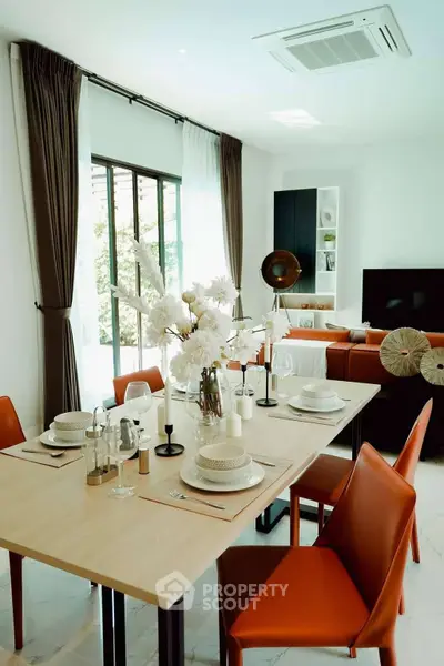 Modern living room with elegant dining area and stylish decor