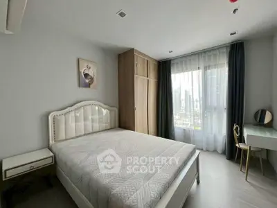 Modern bedroom with stylish decor and city view, featuring a cozy bed and elegant furnishings.