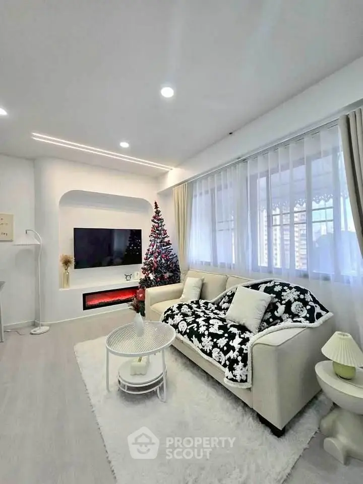 Chic living room with modern decor and festive Christmas tree