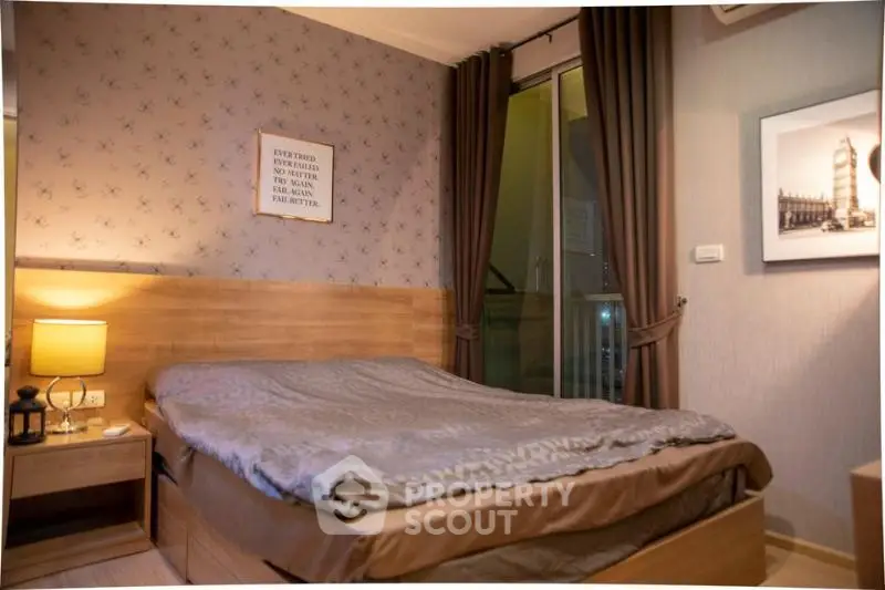Cozy bedroom with elegant decor and balcony access in modern apartment.