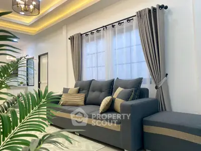 Modern living room with stylish gray sofa and elegant curtains