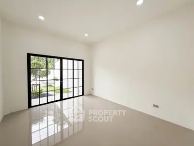 Spacious empty room with large windows and glossy tiled floor, perfect for customization.