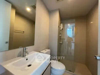 Modern bathroom with sleek fixtures and glass shower enclosure