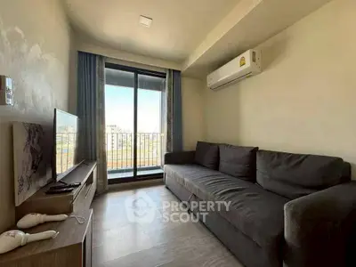 Cozy living room with balcony view and modern furnishings