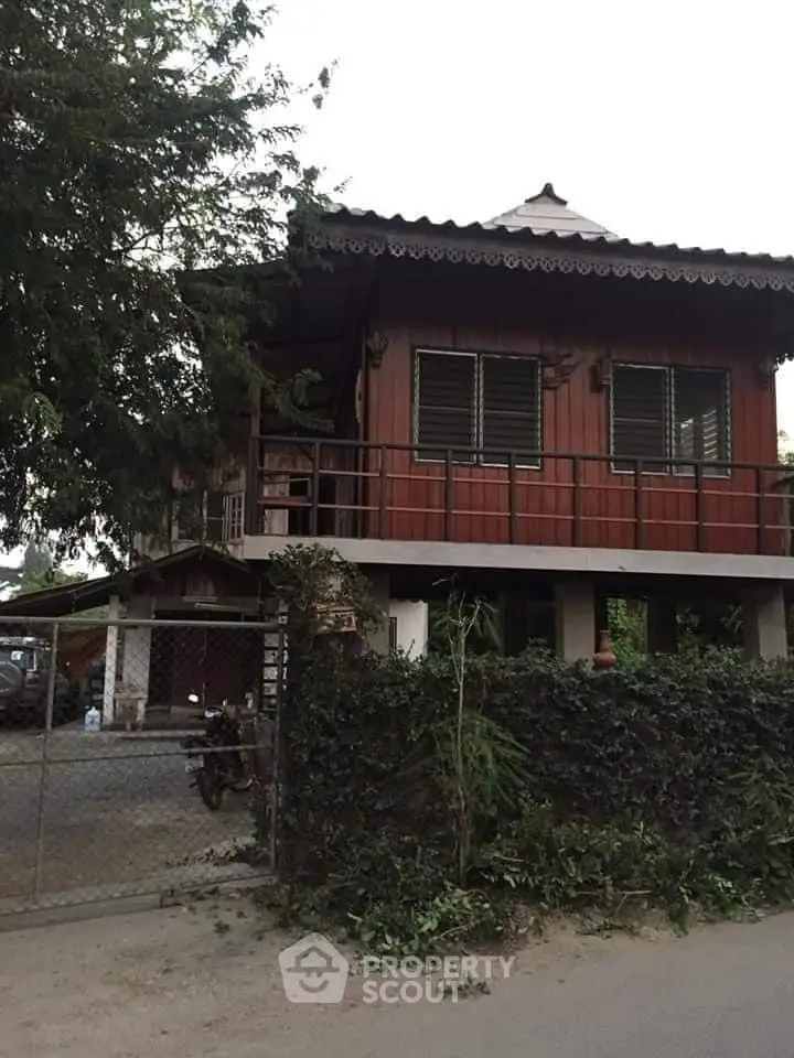 Charming traditional wooden house with elevated design and lush greenery.
