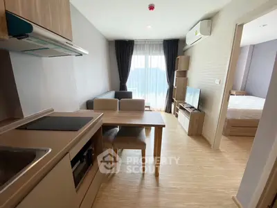 Modern open-plan living room with kitchen and bedroom in a stylish apartment.