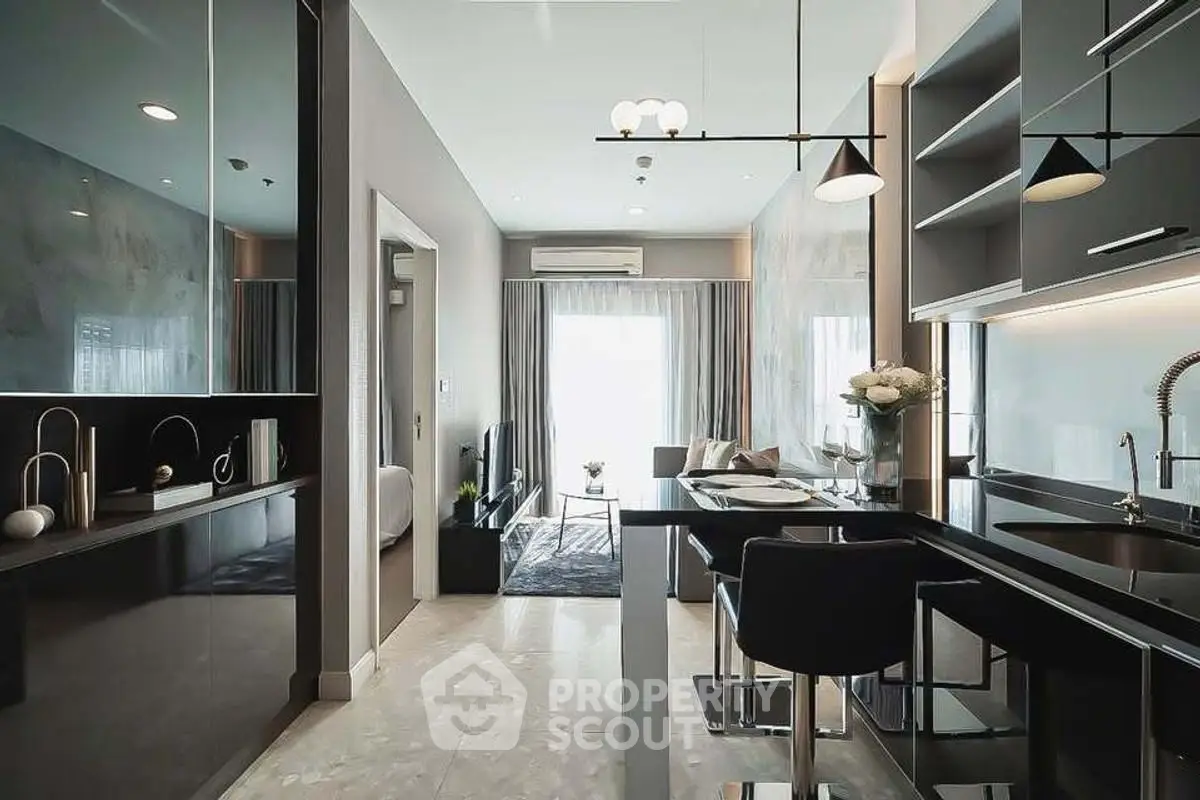 Modern open-layout kitchen and living area with sleek design and natural light.