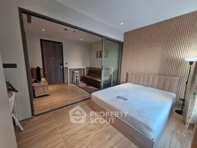 Modern studio apartment with wooden flooring and glass partition