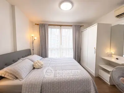 Cozy bedroom with modern decor, featuring a large bed, wardrobe, and natural light from a window.