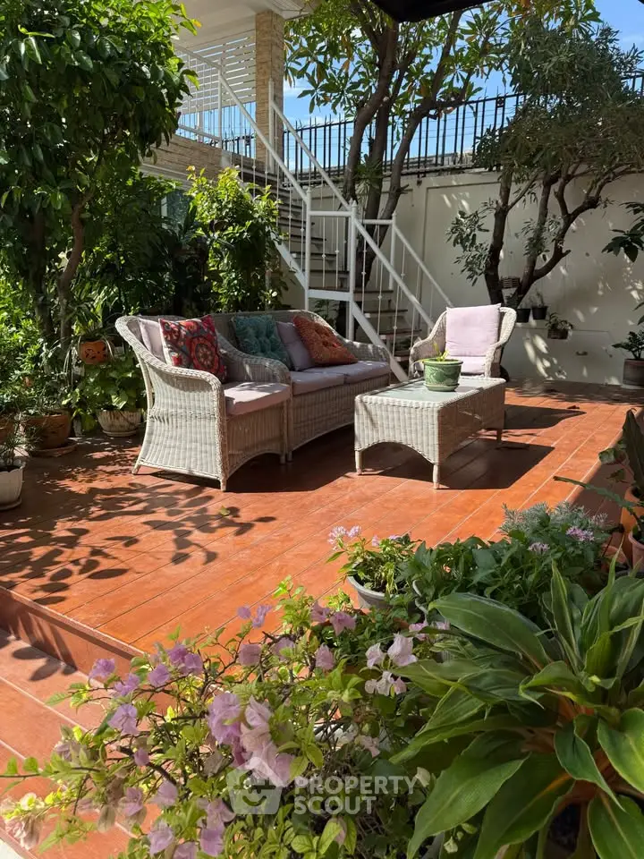 Charming garden patio with cozy wicker furniture and lush greenery