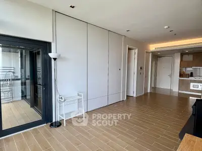 Modern apartment interior with open layout and balcony access