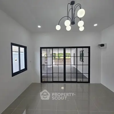 Modern living room with sleek lighting and large glass doors