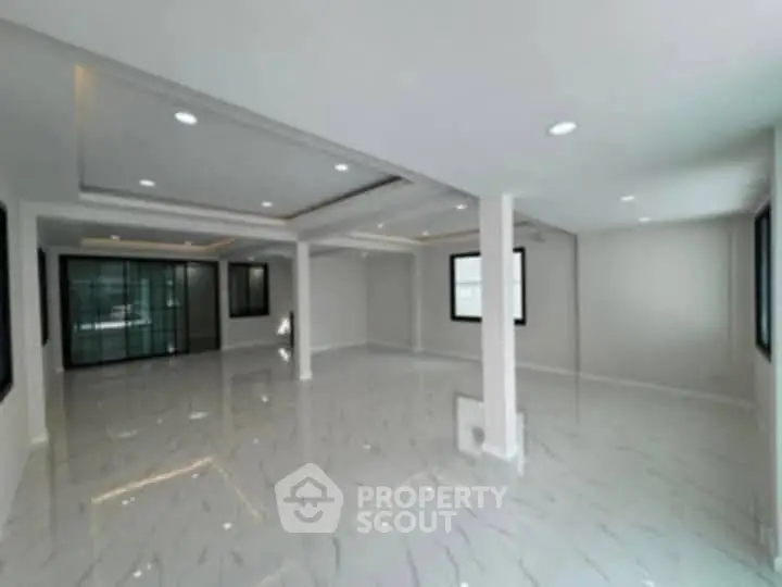Spacious modern living room with sleek design and ample natural light