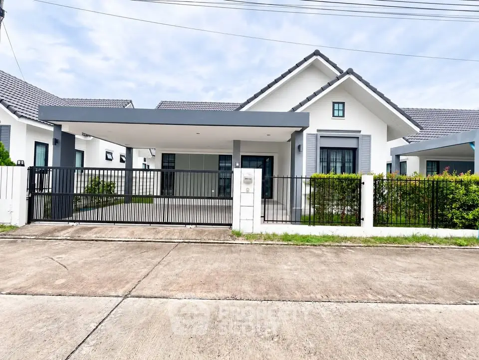 Charming modern single-story house with a spacious driveway and lush greenery, perfect for family living.