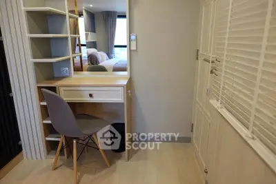 Modern bedroom with stylish desk and chair, featuring sleek design and ample natural light.